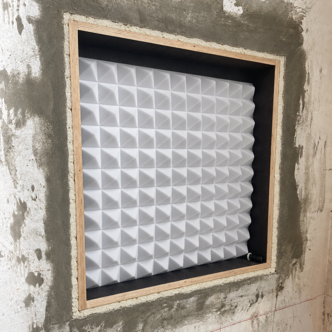 Solid wall: installation frame (backbox) aligned centrally using the blanking panel and both battens; approximately 2 cm gap for construction foam